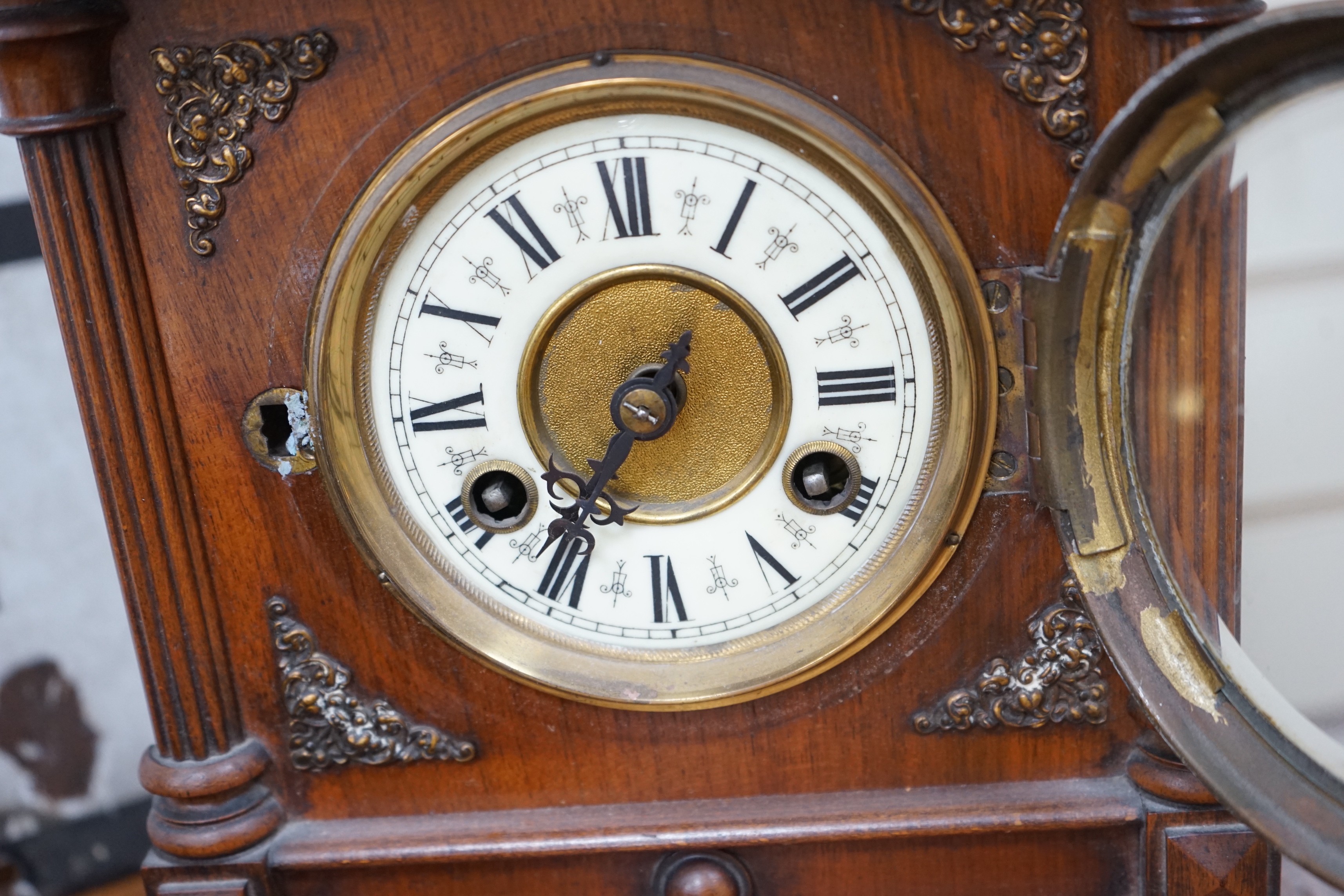 A 19th century German walnut mantel clock with key and pendulum, 40cm tall